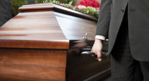 homem segurança caixão em funeral